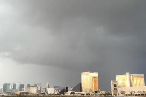 Dark storm clouds over the south end of the Las Vegas Strip, the gold Mandalay Bay towers lit by sun