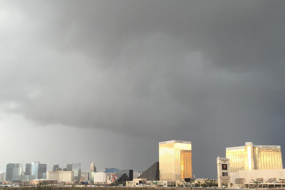 Dark storm clouds over the south end of the Las Vegas Strip, the gold Mandalay Bay towers lit by sun